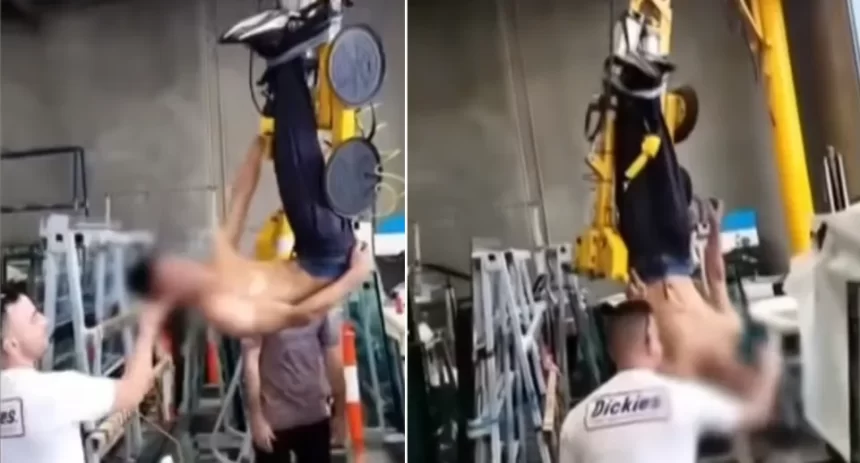 Apprentice being bullied while hanging upside down underneath a crane at work