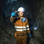 a miner gives a thumbs up in a mine