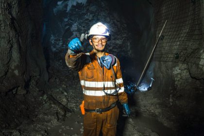 a miner gives a thumbs up in a mine