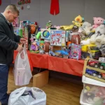 Man looks at gifts on the table