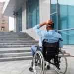 Man in wheelchair approaches building