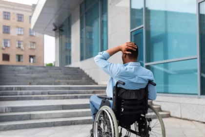 Man in wheelchair approaches building