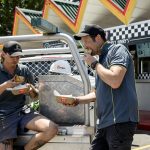 tradies eating tradie pies in the back of a ute