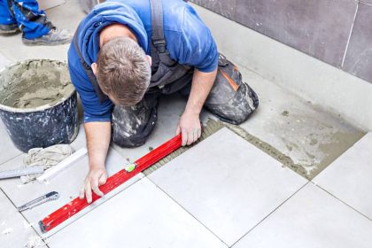 plumber putting tiles in bathroom
