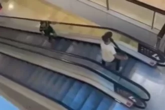 Tradie fending off stabber on escalator with bollard