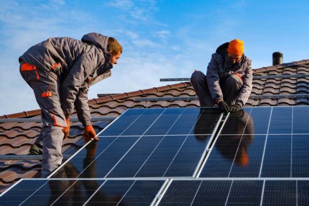 Rooftop solar system being installed by tradesmen