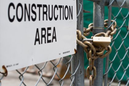 Construction site closed with padlock on gate