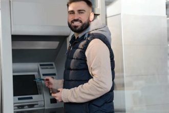 Smiling man at ATM