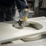 Man polishing engineered stone on construction site