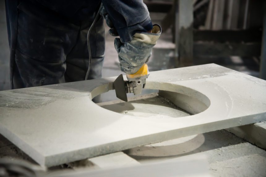 Man polishing engineered stone on construction site