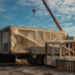Tiny home being craned in on construction site in Australia
