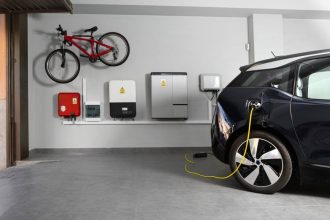 An electric car charging from battery in home garage