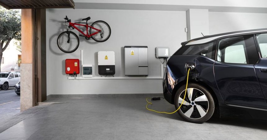An electric car charging from battery in home garage