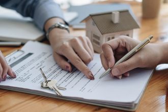Home buyer signing a contract