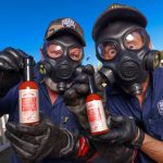 Shank brothers in gas masks holding their chilli sauce