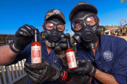 Shank brothers in gas masks holding their chilli sauce