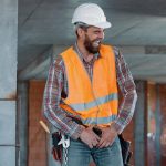 Tradies in hard hats laughing on work site