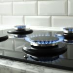 a gas stove with the flame on