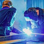 Two welders in protective gear