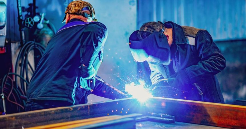 Two welders in protective gear