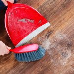 home owner cleaning up dust