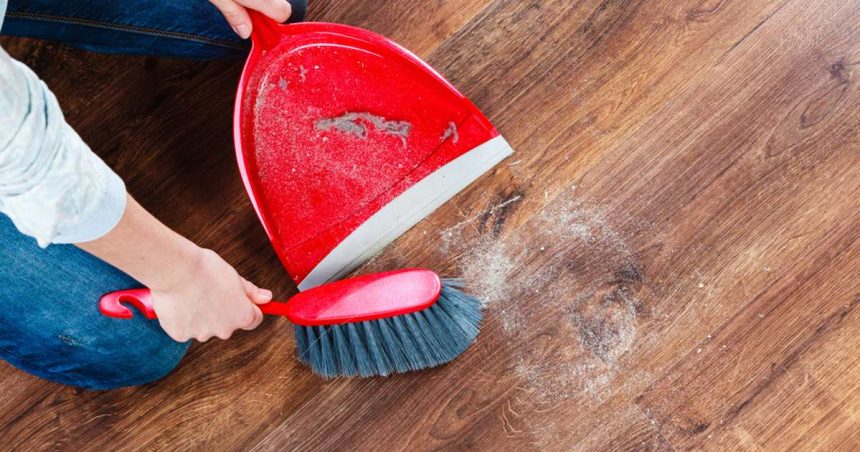 home owner cleaning up dust