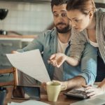 Couple looking over expensive insurance bill