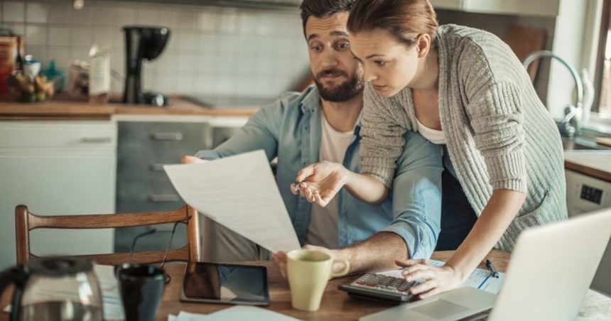 Couple looking over expensive insurance bill