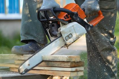 Chainsaw cutting into construction material at home