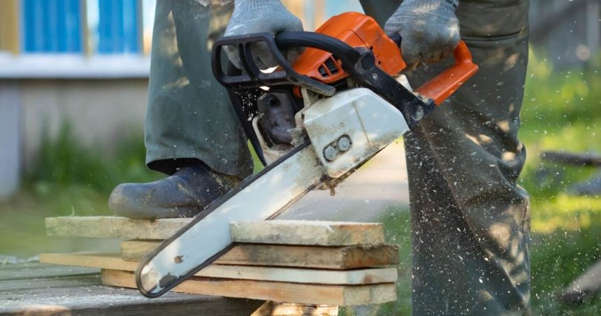 Chainsaw cutting into construction material at home