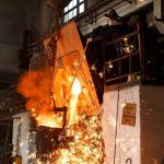 steel mill worker overseeing production