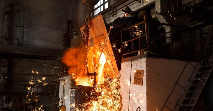 steel mill worker overseeing production