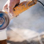 Man cutting engineered stone with grinder