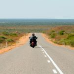 Man on motorcycle on open Australian road