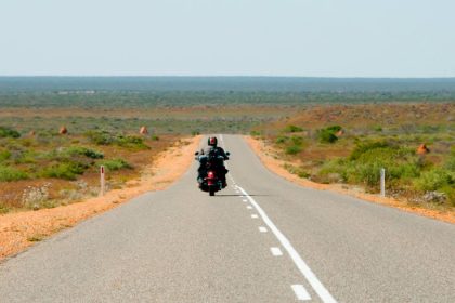 Man on motorcycle on open Australian road