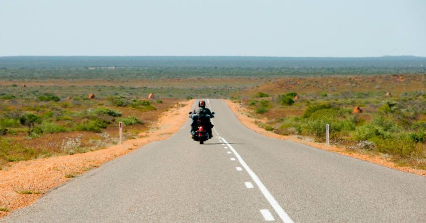 Man on motorcycle on open Australian road