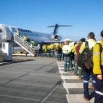 Migrant workers getting onto plane