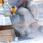 Engineered stone being cut by tradie