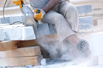 Engineered stone being cut by tradie