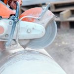 Construction worker cutting silica product