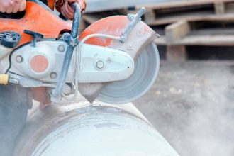 Construction worker cutting silica product