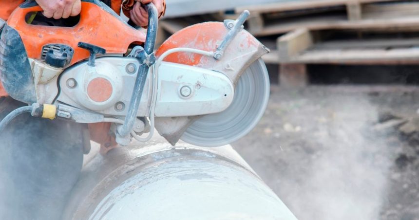 Construction worker cutting silica product