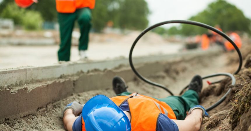 Apprentice lying on ground after being injured at work