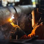 Welder working in factory