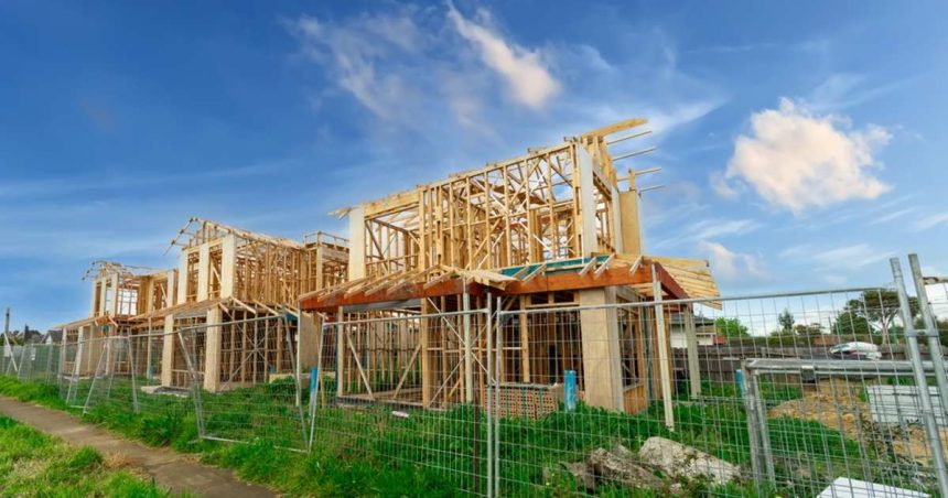 Australian homes under construction behind steel fence