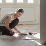 Woman renovating the floors of her home