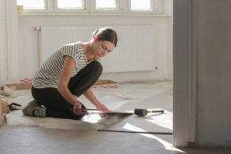 Woman renovating the floors of her home