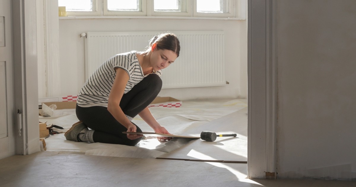 Woman renovating the floors of her home