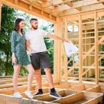 Couple inspecting their home while it's under construction