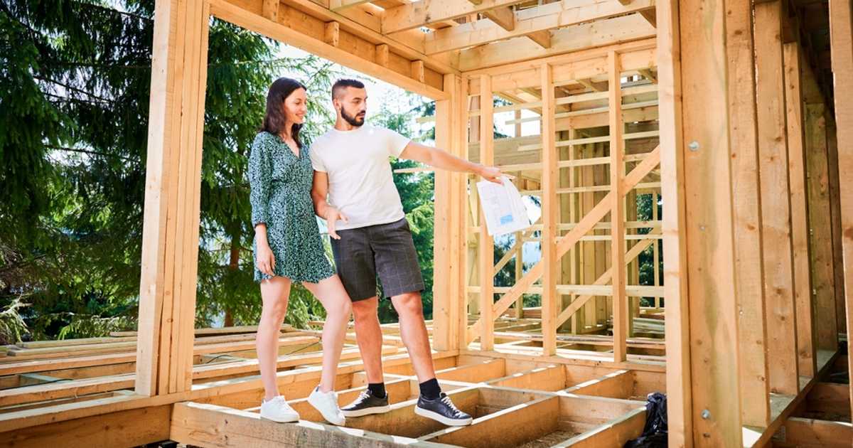 Couple inspecting their home while it's under construction